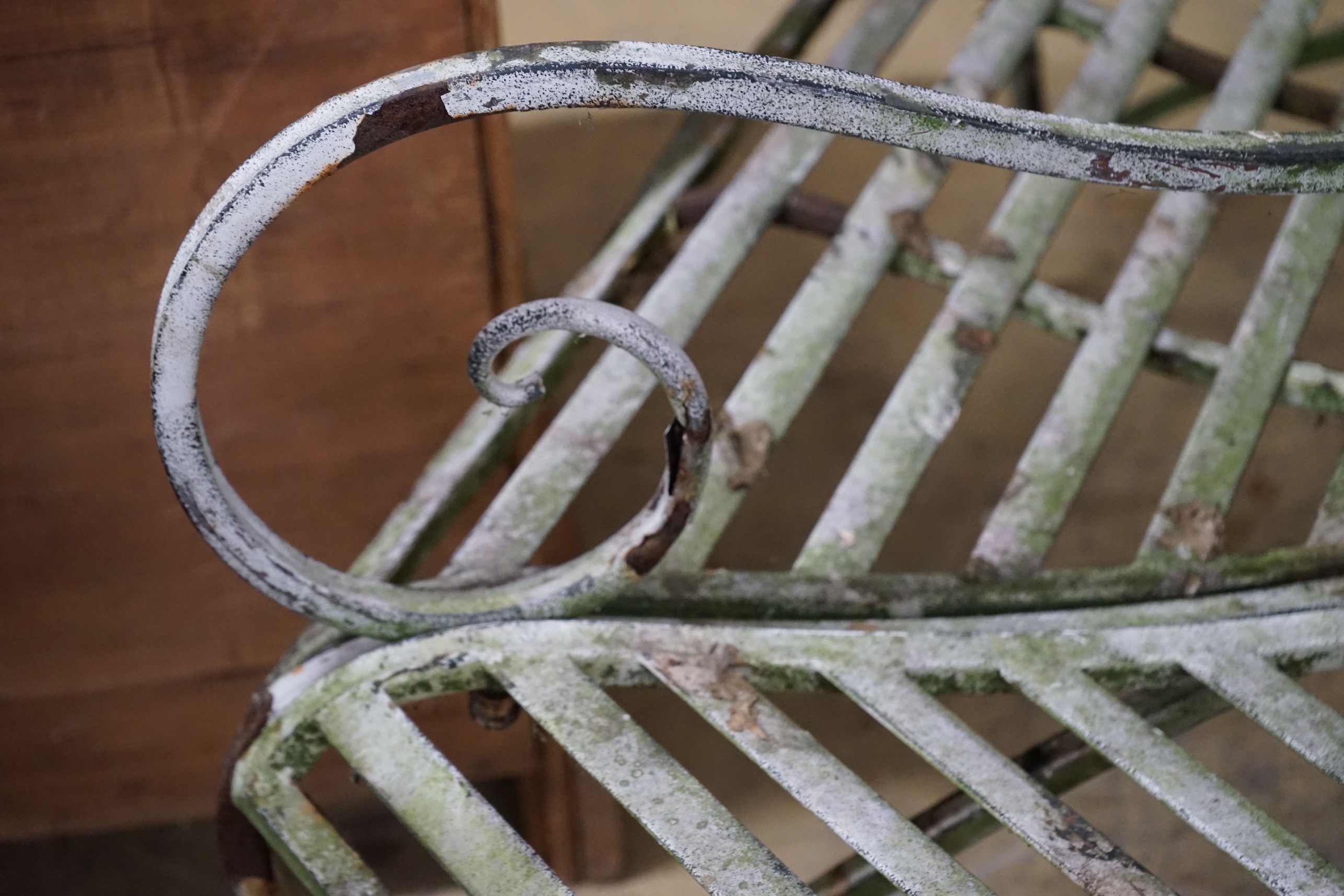 A painted wrought iron hexgonal tree seat, length 150cm, height 77cm